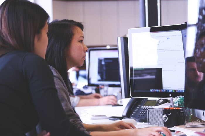 workers staring at a screen to show why we need vitamins for eyes