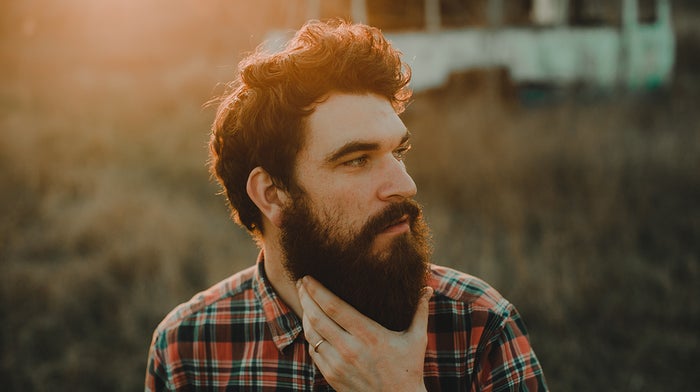 Man stroking beard