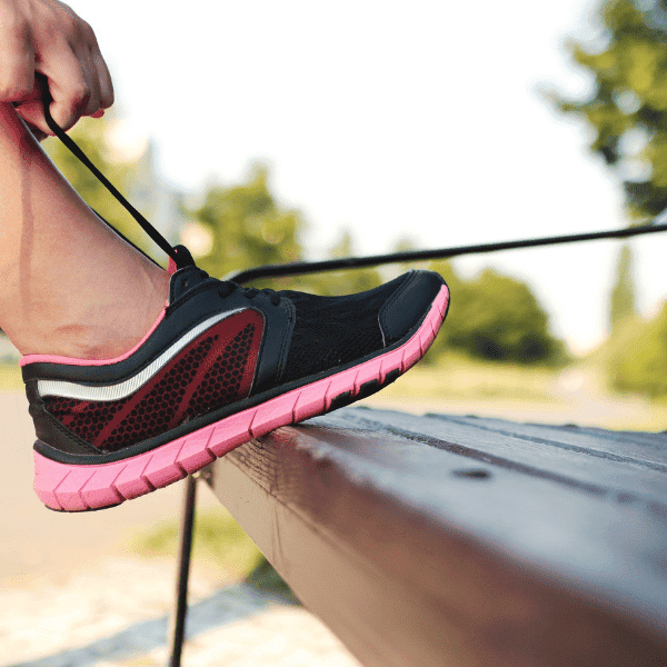 woman tying running shoe