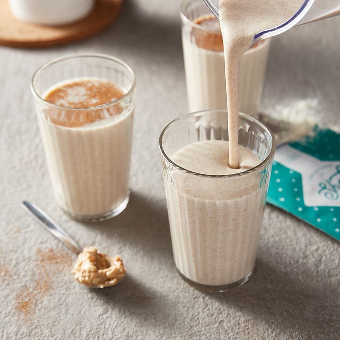 peanut butter smoothie being poured into glass