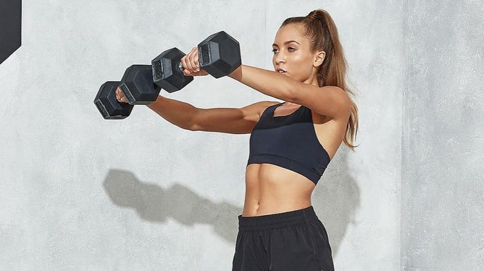 athletic woman lifting dumbbells