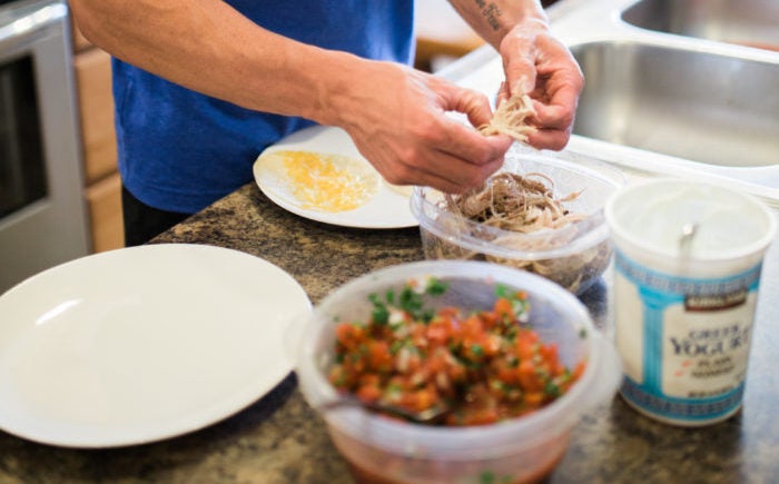 Trainer Zac portioning food for healthy tacos.