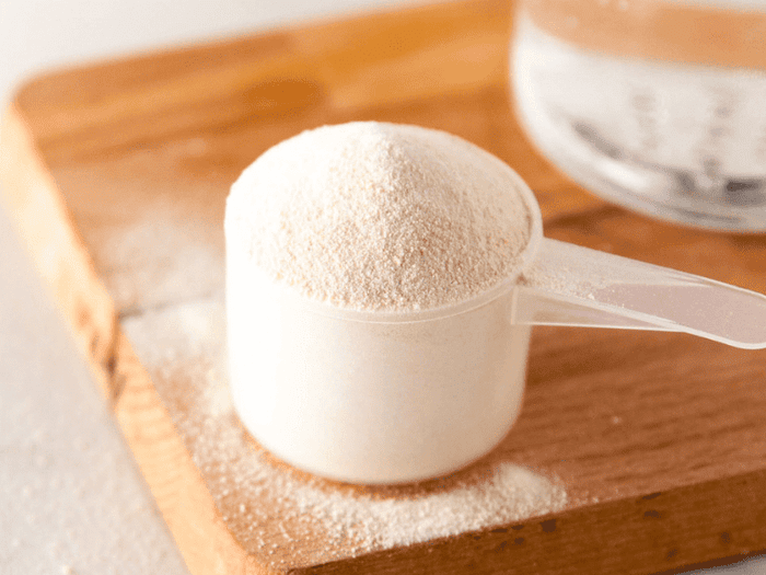 A scoop filled with whey protein powder