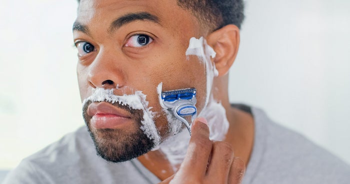 Man shaving with a Gillette razor.