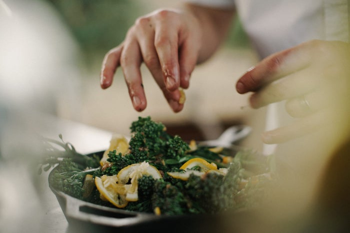 person cooking vegetables