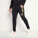 Jogginghose mit Markenstreifen (skinny Fit) – schwarz/golden
