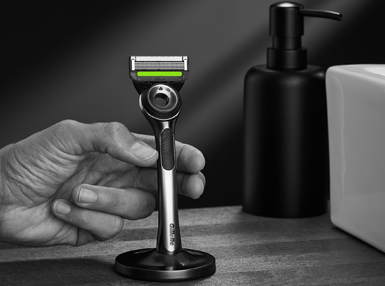 Hand Reaching For Exfoliating Razor Magnetic Stand | Gillette Labs UK