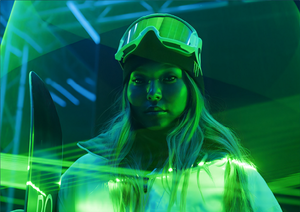 Man carrying a Monster Energy surfboard on a glowing green background