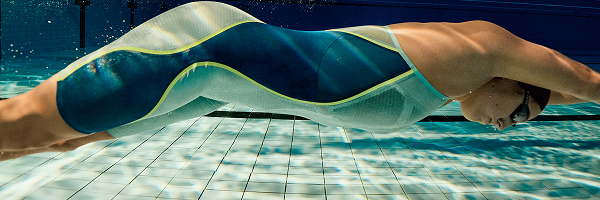 Shop all Fastskin – man underwater after diving into the pool wearing Fastskin 2.0 Molten Blur jammers.
