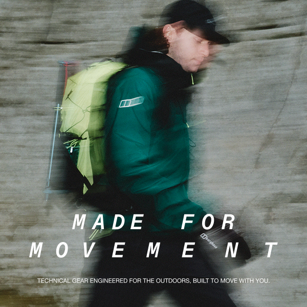 A image taken through a window with rain down it of a close up of someone wearing a Green Berghaus Jacket