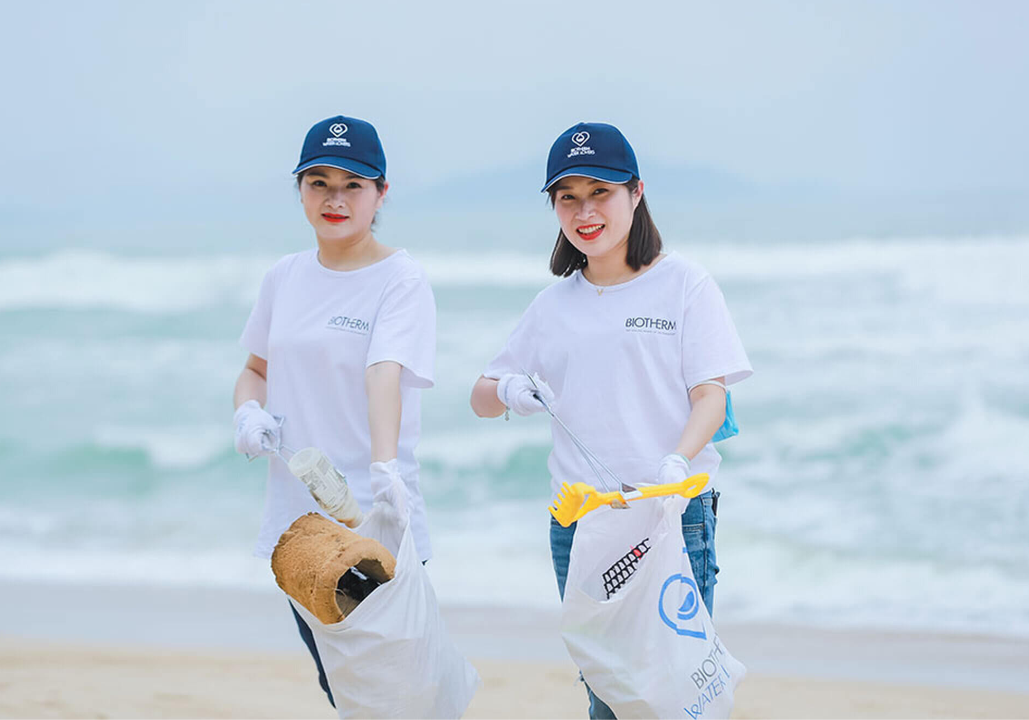 Two Children Cleaning Up The Beach