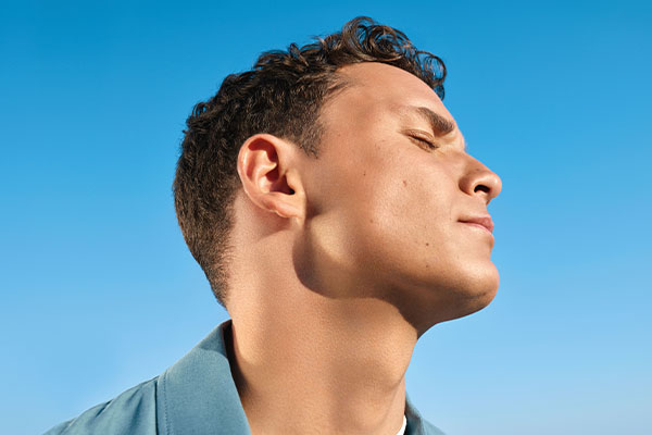 Man against blue sky background