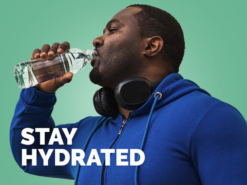 A man drinking from a water bottle with text overlay "stay hydrated"