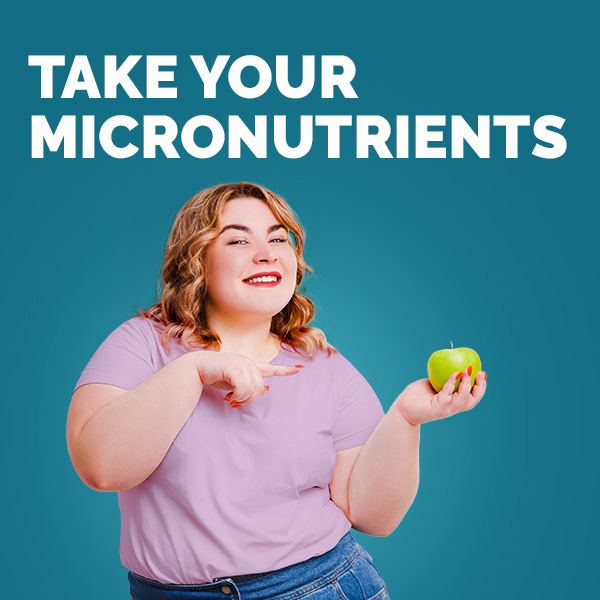 A women pointing to an apple with the text overlay "take your micronutrients"