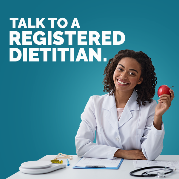 a female doctor holding an apple with text overlay "Talk To A Registered Dietitian"