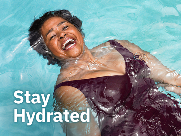 A man drinking from a water bottle with text overlay "stay hydrated"