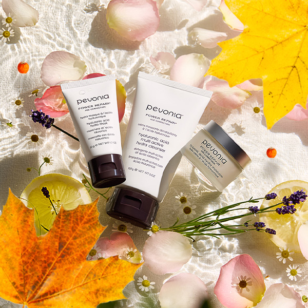 Pevonia's new Hyaluronic Acid cleanser lay in a bed of water, accompanied by the natural ingredients of the product including lemon, rose petals and Lavendar. 