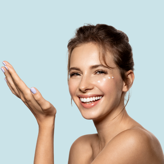 Womeh with her hand out and Product spotted on her face to show Pevonia Skin Care Products and promote the Refer a Friend Scheme