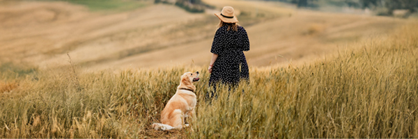 Woman with dog in a field