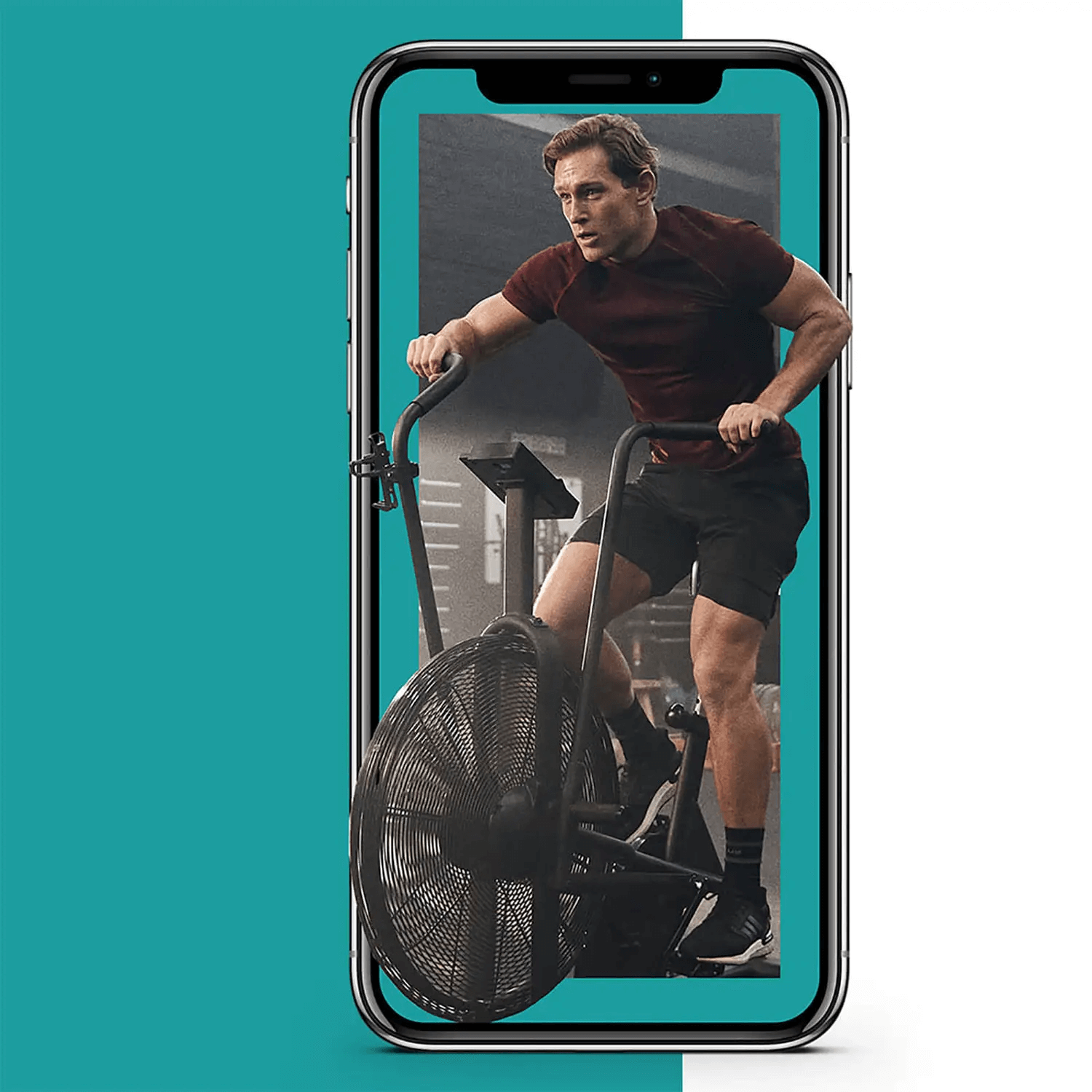 Graphic on a mobile phone of a man working out on a black assault bike in the gym.