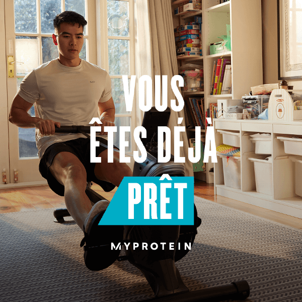 A man workout out on a rowing machine at home with the words 'You're Already Ready - MYPROTEIN' overlaying.