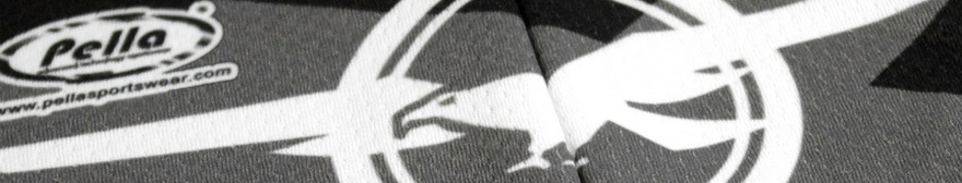 close-up black and white image of a pella cycling jersey's material around the zip, with the logo in view on the left
